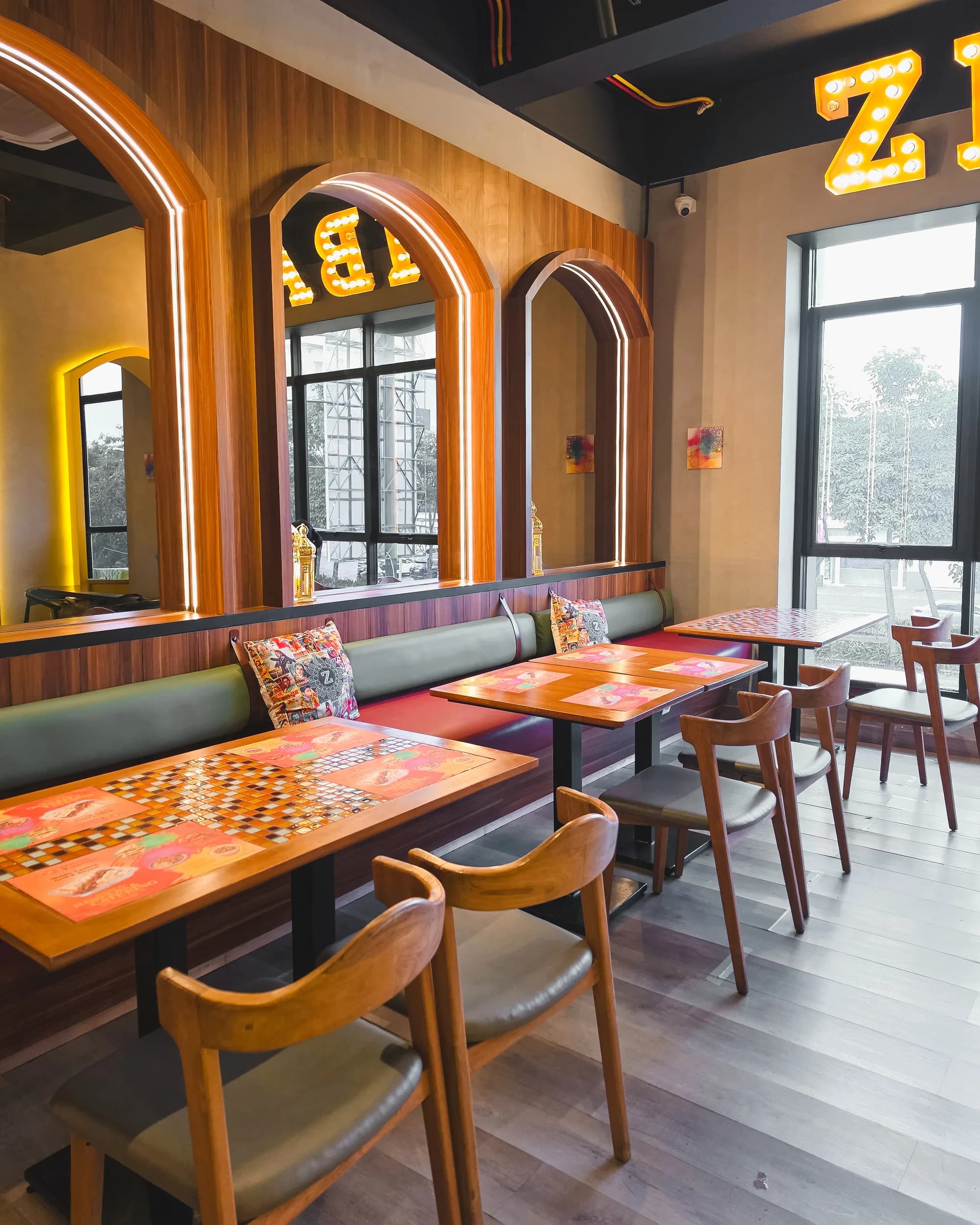 Dining area with arched mirrors at Zibaa Gading Serpong