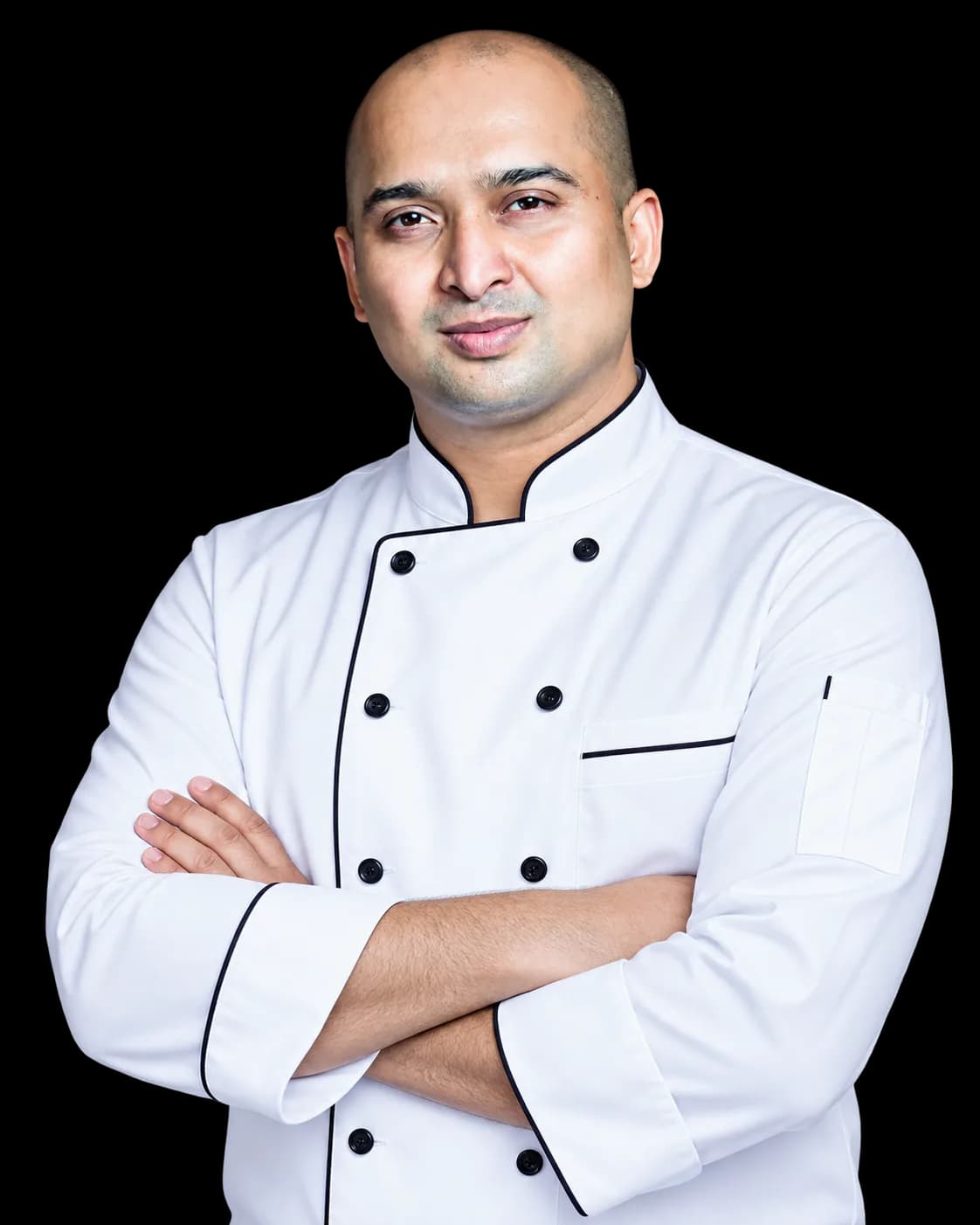 Oswald Fernandes, founder of Zibaa Indonesia, in a chef jacket with arms crossed